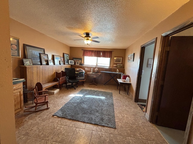 office space with a textured ceiling and a ceiling fan