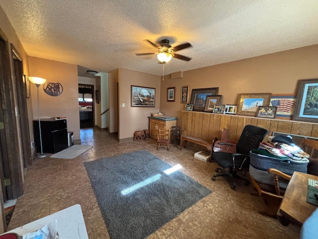 office area featuring ceiling fan and a textured ceiling