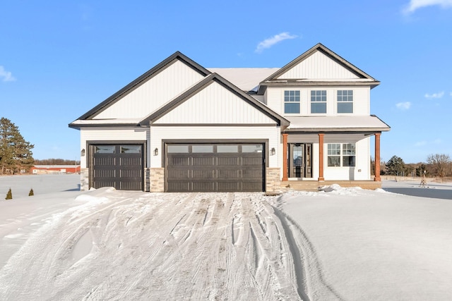 view of front of home with a garage and stone siding