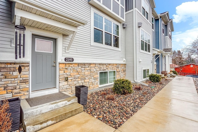 doorway to property featuring stone siding