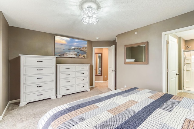 bedroom with light carpet, connected bathroom, baseboards, and a textured ceiling