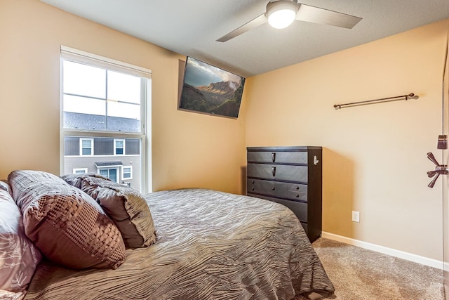 bedroom with carpet, baseboards, and ceiling fan