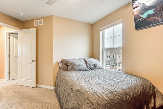 carpeted bedroom featuring visible vents and baseboards