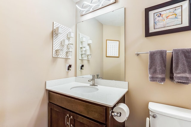 half bathroom with toilet and vanity