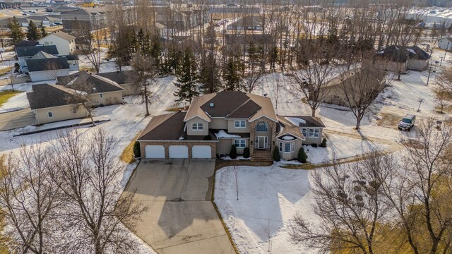 snowy aerial view with a residential view