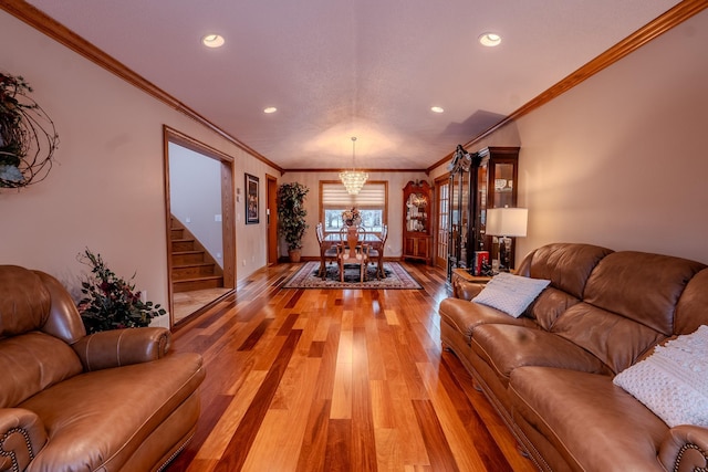 living room featuring stairs, recessed lighting, a chandelier, and light wood-style floors