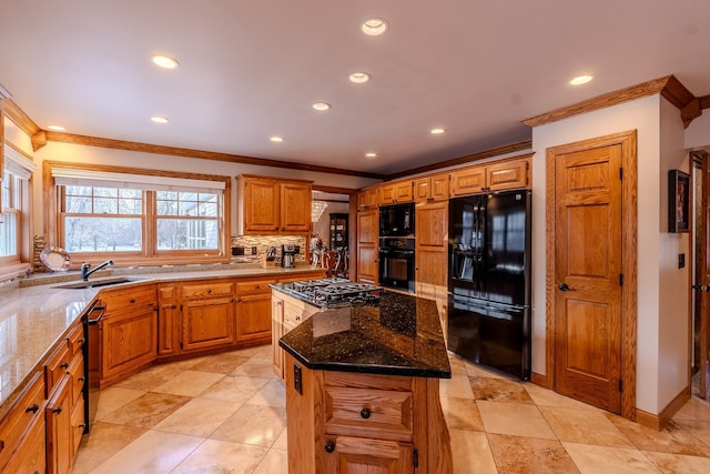 kitchen with dark stone counters, black appliances, ornamental molding, and tasteful backsplash