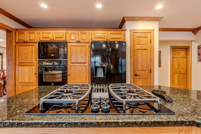 kitchen featuring black appliances, ornamental molding, dark stone countertops, and recessed lighting