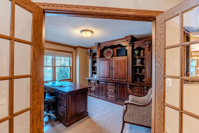 office space with a textured ceiling, ornamental molding, and light colored carpet