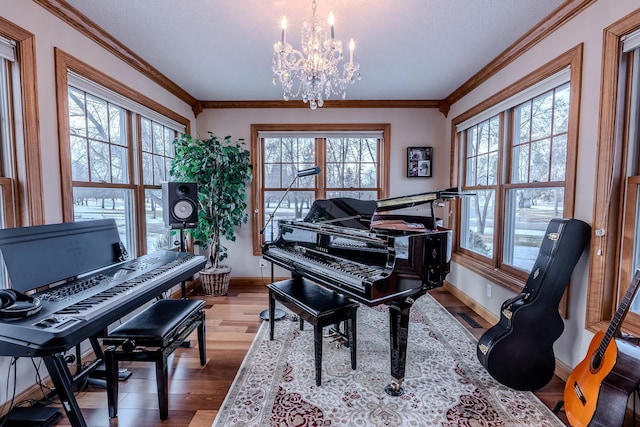 living area featuring baseboards, a chandelier, crown molding, and wood finished floors