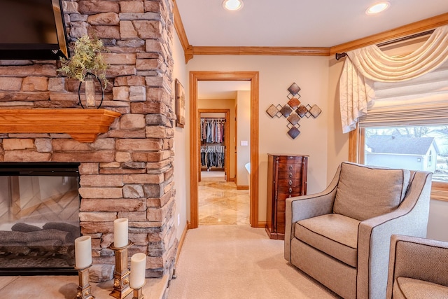 living area with a fireplace, recessed lighting, ornamental molding, light carpet, and baseboards