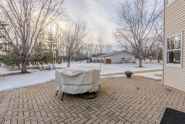 snow covered patio with grilling area