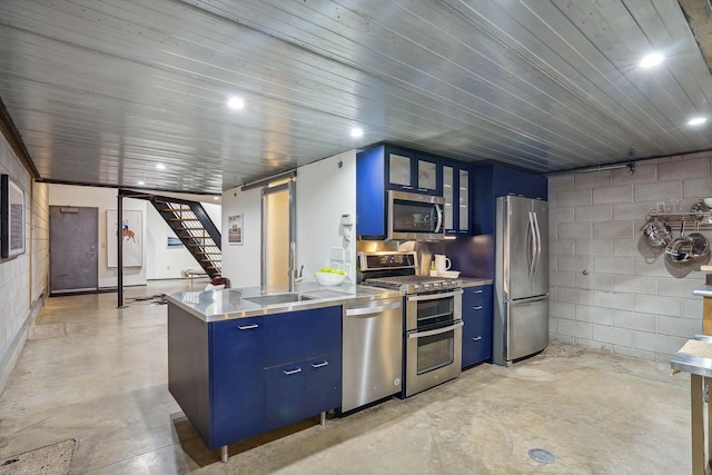 kitchen featuring appliances with stainless steel finishes, stainless steel countertops, and blue cabinets