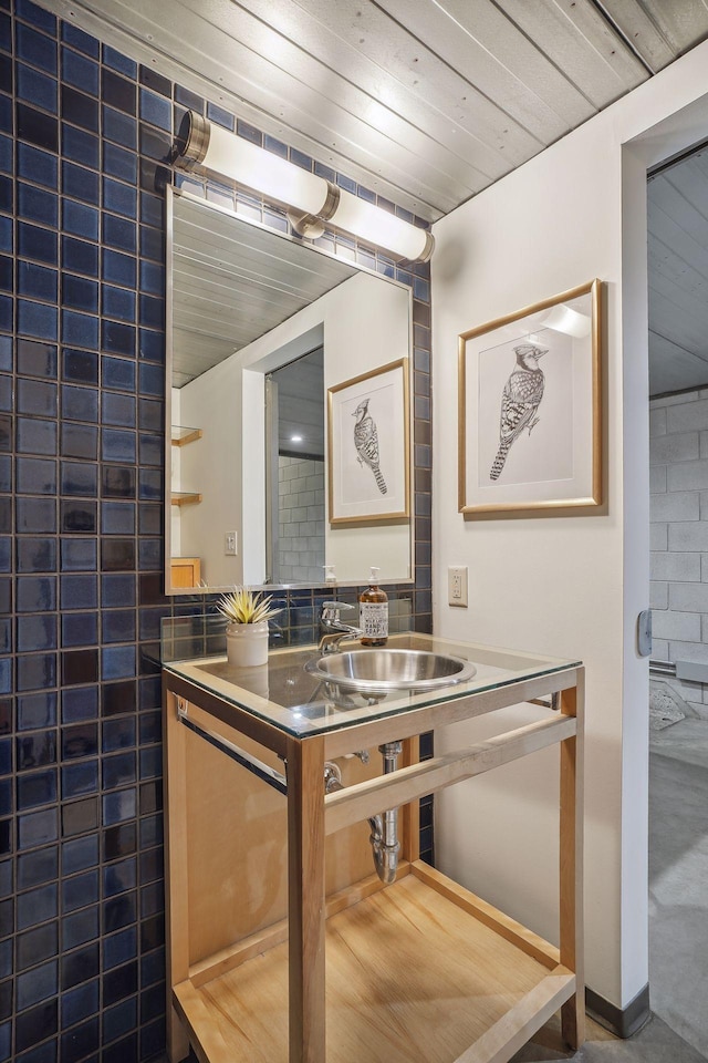 kitchen featuring wooden ceiling and a sink