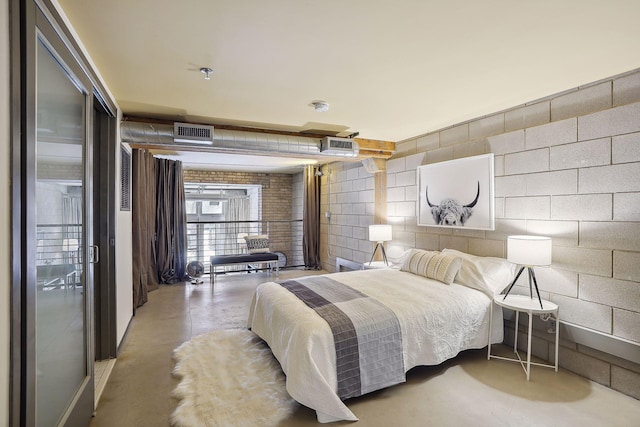 bedroom featuring concrete block wall, visible vents, and concrete flooring