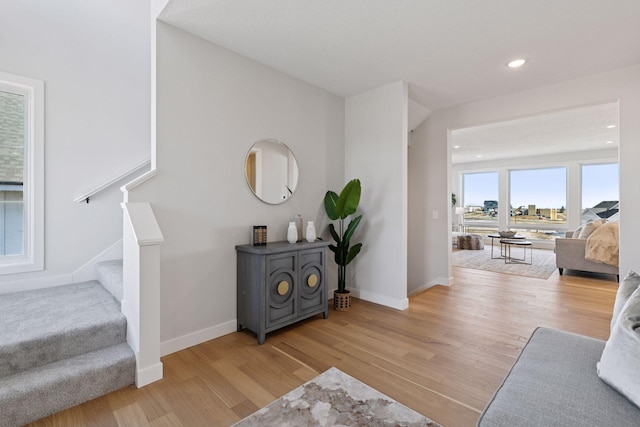 interior space featuring stairs, recessed lighting, wood finished floors, and baseboards