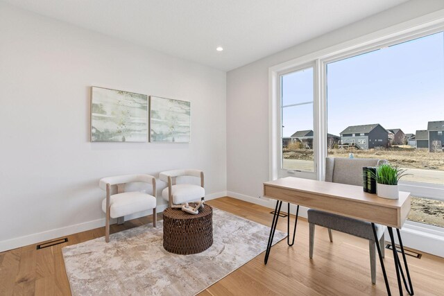 interior space with light wood finished floors, recessed lighting, visible vents, and baseboards