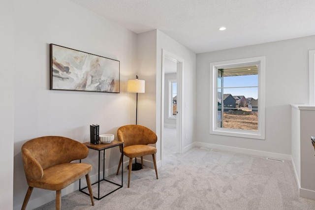 living area featuring a textured ceiling, recessed lighting, carpet flooring, and baseboards