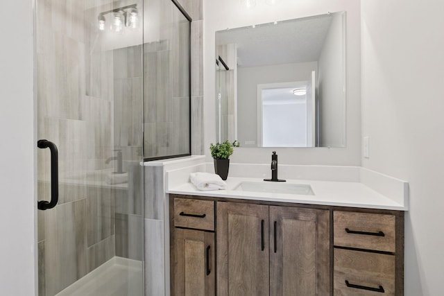 full bath with a stall shower and vanity