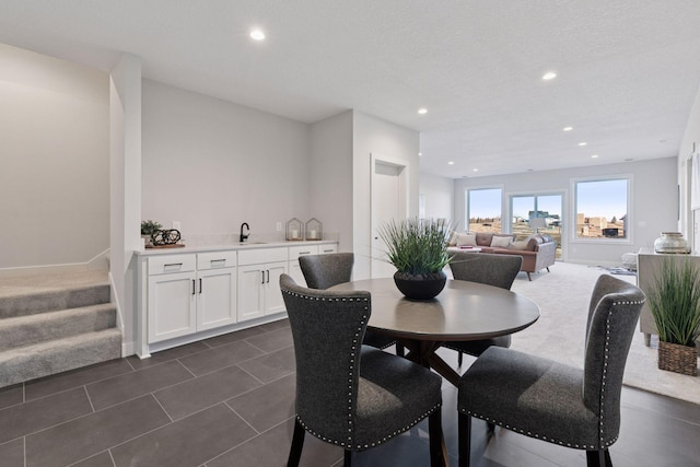 dining area with recessed lighting, dark tile patterned flooring, stairway, and baseboards