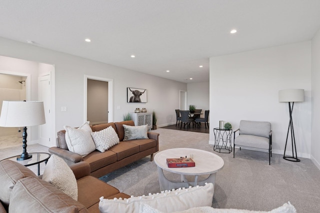 living room featuring carpet floors, recessed lighting, and baseboards