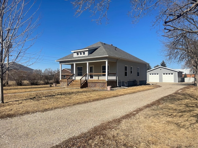 view of front of house with a garage, a porch, roof with shingles, and an outdoor structure