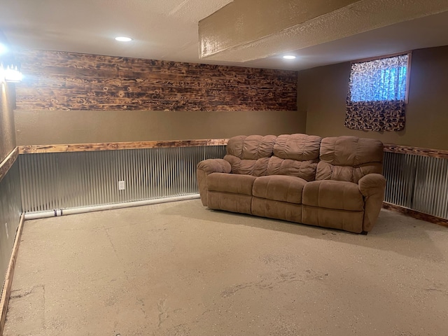 interior space featuring a wainscoted wall, a textured ceiling, and recessed lighting