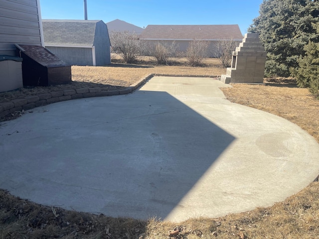 view of patio featuring an outdoor structure and a shed