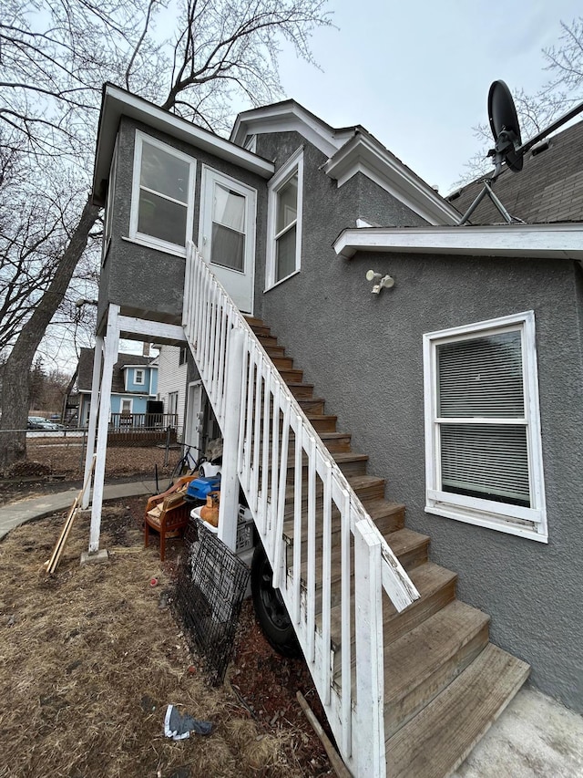 view of property exterior featuring stairs and stucco siding