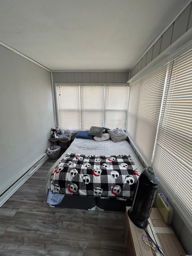 interior space featuring baseboard heating and wood finished floors