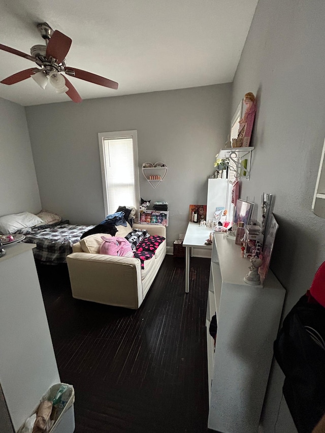 bedroom with ceiling fan and dark wood finished floors