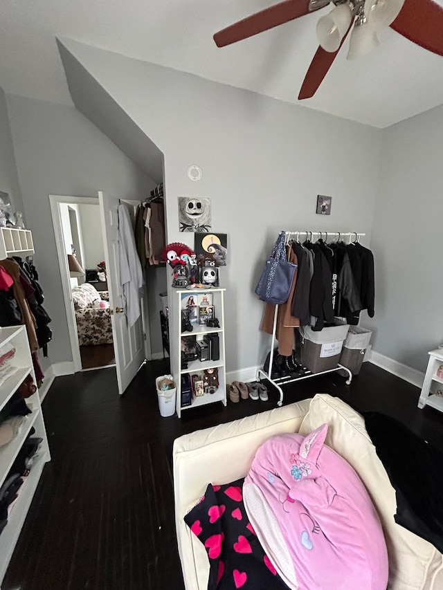 spacious closet with a ceiling fan, lofted ceiling, and wood finished floors