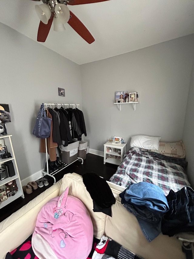 bedroom with baseboards, a ceiling fan, and wood finished floors