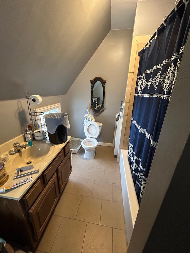 full bathroom featuring toilet, tile patterned floors, vaulted ceiling, and vanity