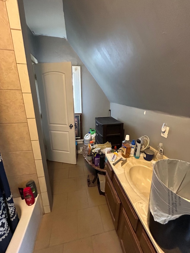 bathroom featuring vaulted ceiling, vanity, and tile patterned floors