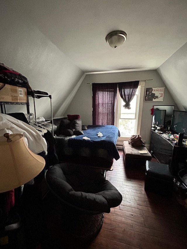 bedroom with lofted ceiling and wood-type flooring