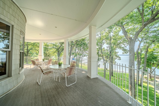 unfurnished sunroom with a water view