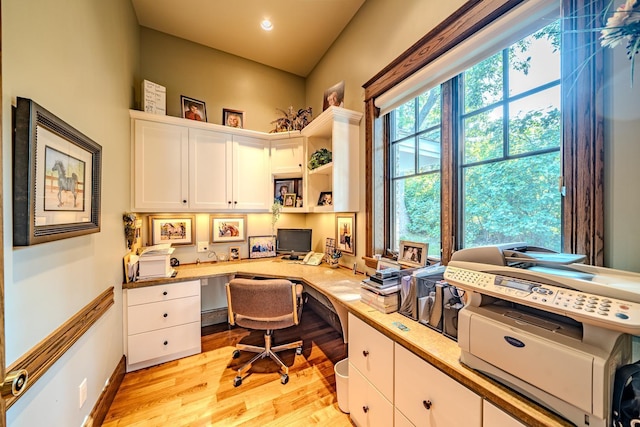 office area with built in desk and light wood-type flooring