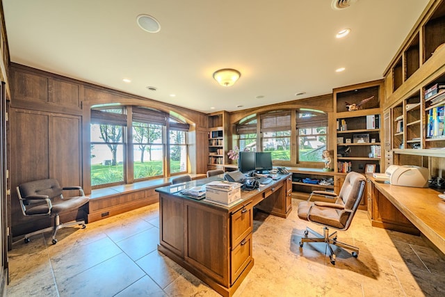 office area with wooden walls, built in shelves, and recessed lighting