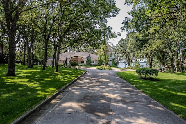 view of front of property with driveway and a front lawn