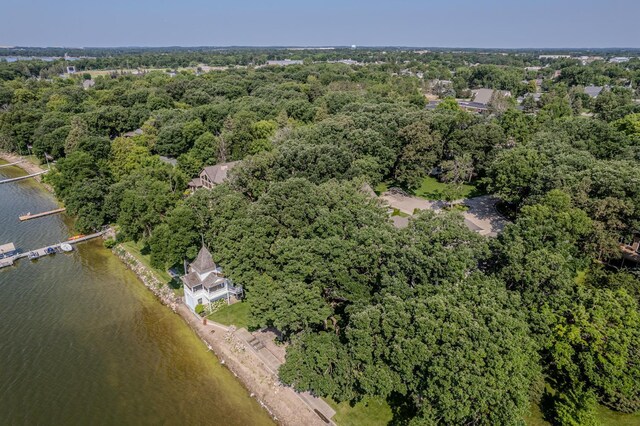 aerial view with a water view and a wooded view