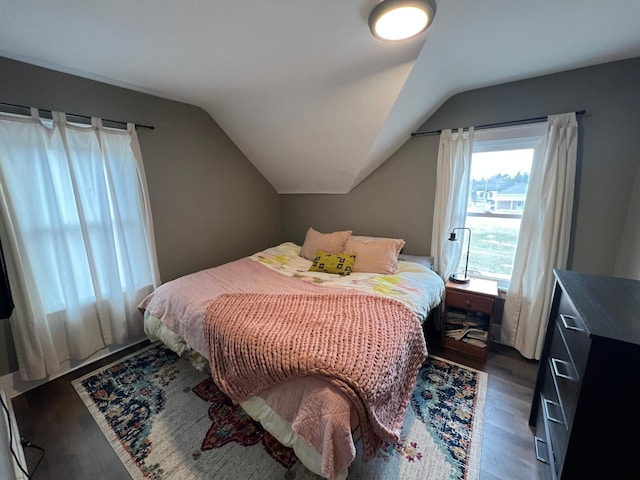 bedroom featuring lofted ceiling and wood finished floors