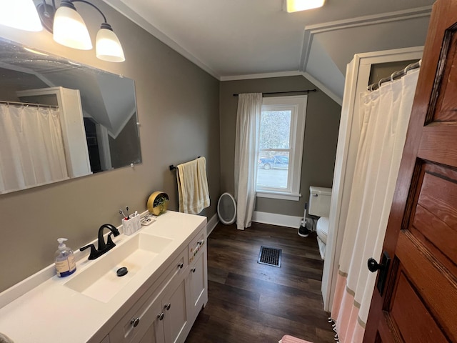 full bath with vanity, wood finished floors, visible vents, ornamental molding, and toilet