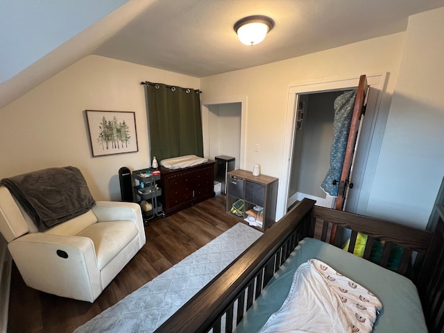 bedroom featuring vaulted ceiling and wood finished floors