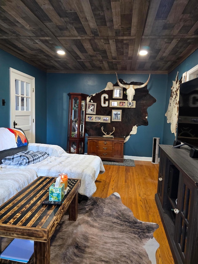 bedroom with light wood-type flooring and wood ceiling