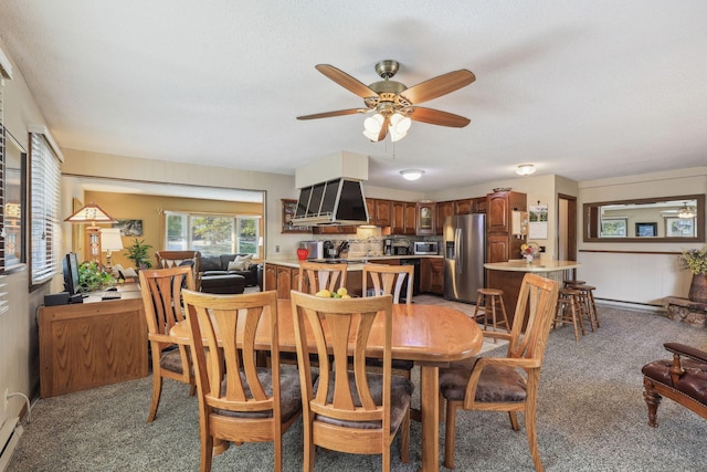 dining area featuring light carpet and ceiling fan