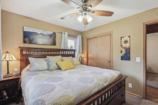 carpeted bedroom with a closet, a ceiling fan, and baseboards