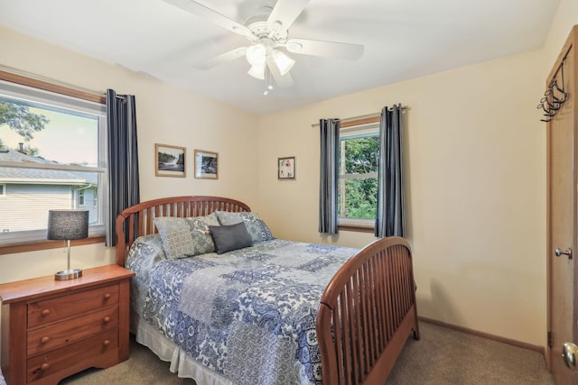 carpeted bedroom featuring baseboards and a ceiling fan