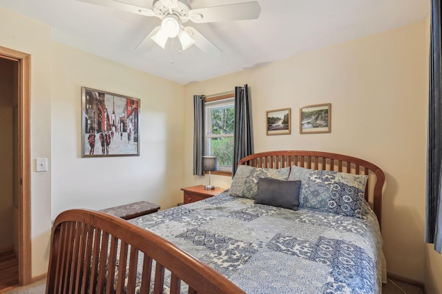 bedroom with ceiling fan and baseboards