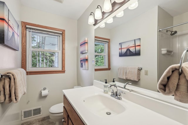 full bath with a shower, visible vents, vanity, and toilet